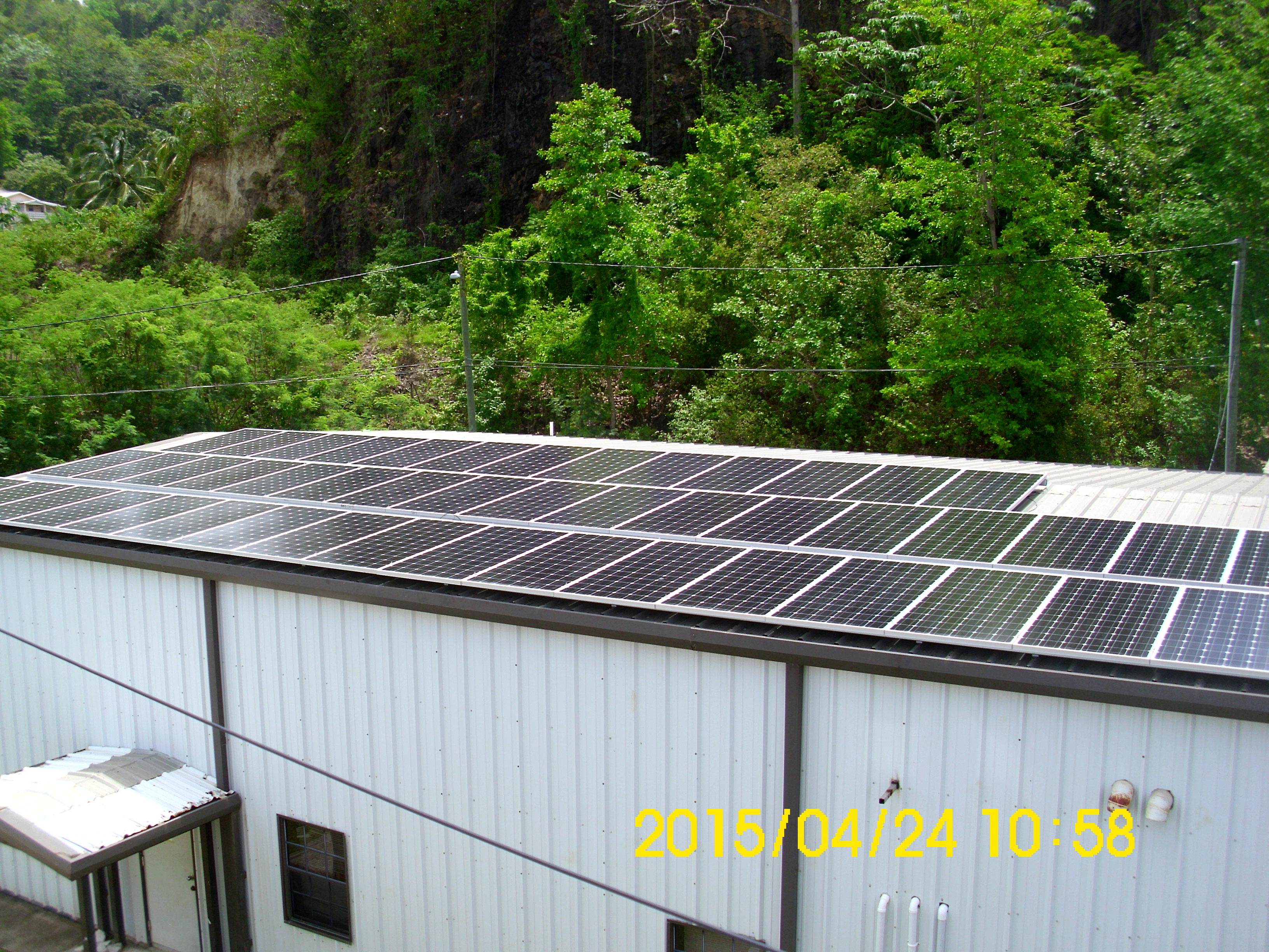 Commercial solar photovoltaic system installation showing large-scale solar panel array